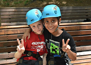 two kids holding up peace signs