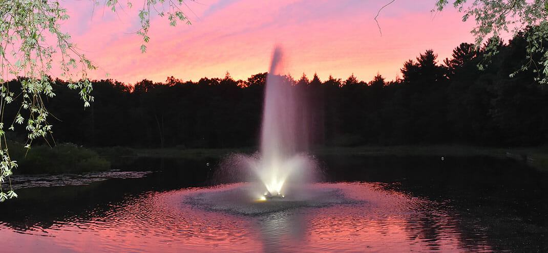 fountain with a sunset in the background