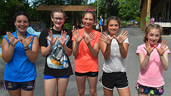 campers with hands up