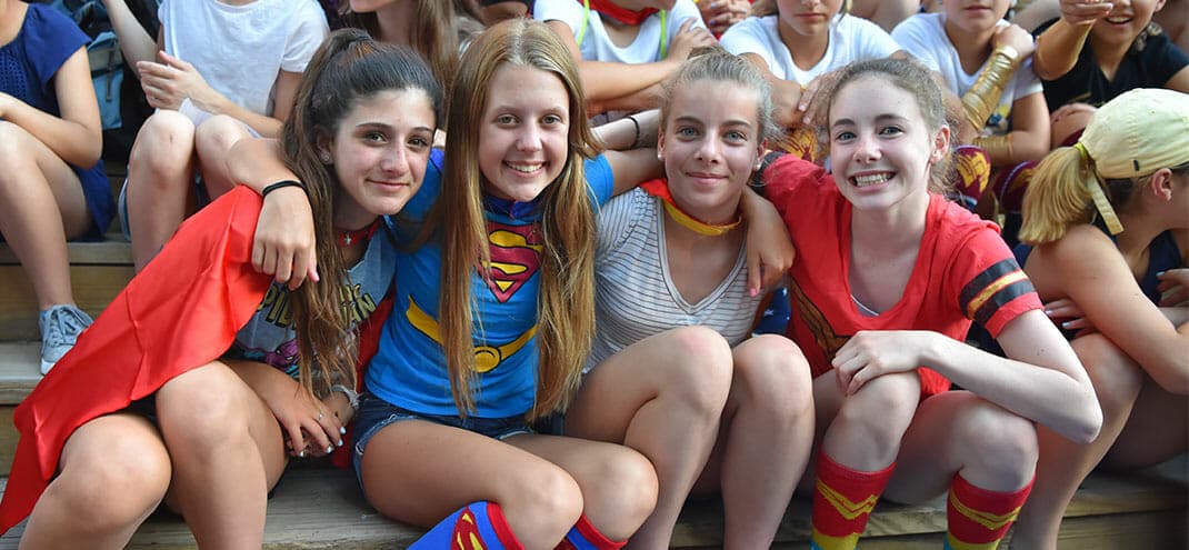 four girls dressed as super heroes
