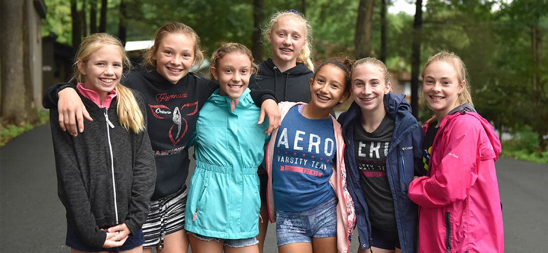 7 girls smiling at camp