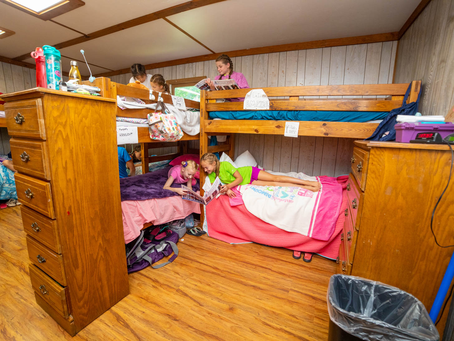 interior of one of the cabins with campers in their bunk beds