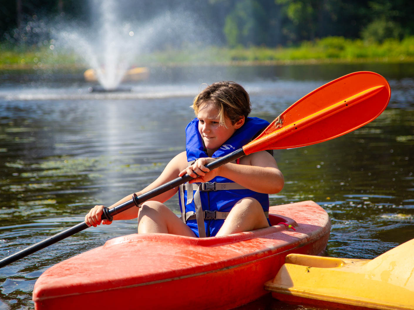 boy kayaking in the pond