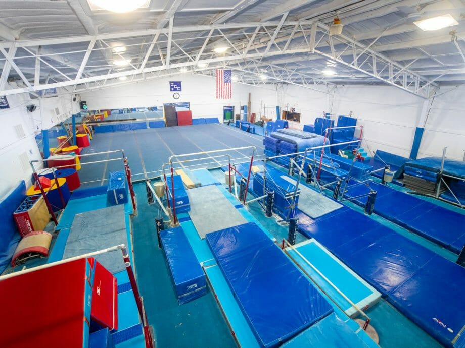 corner view of the bar gym showcasing the high bar and uneven bars