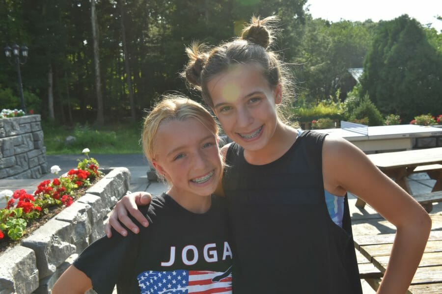 girls smiling at international gymnastics camp