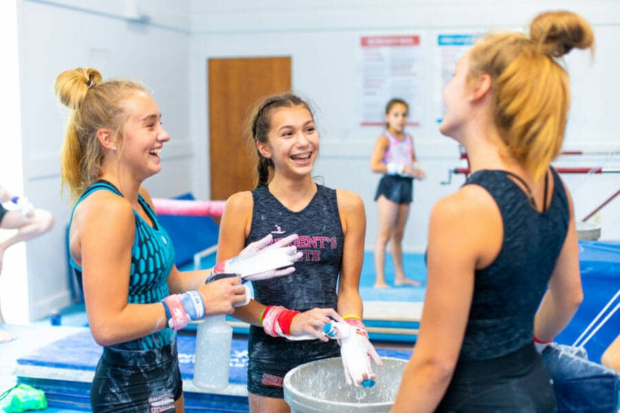 female gymnasts putting powder on hands