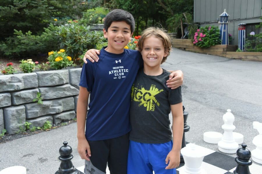 two boys hugging at international gymnastics camp