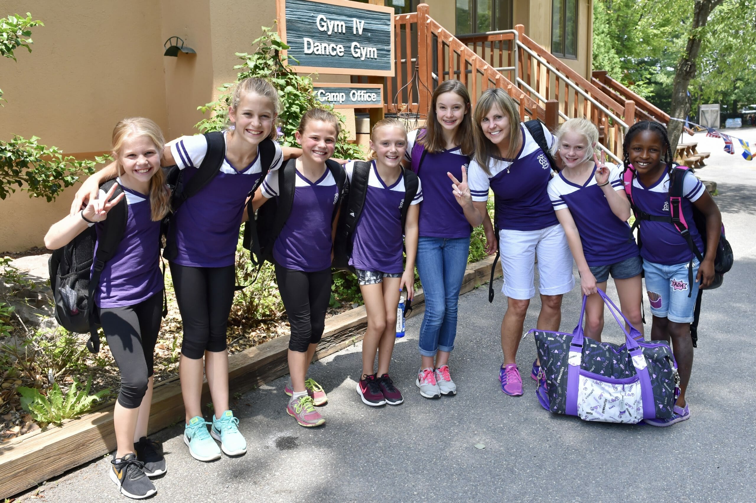 summer campers smiling in front of dance gym at IGC