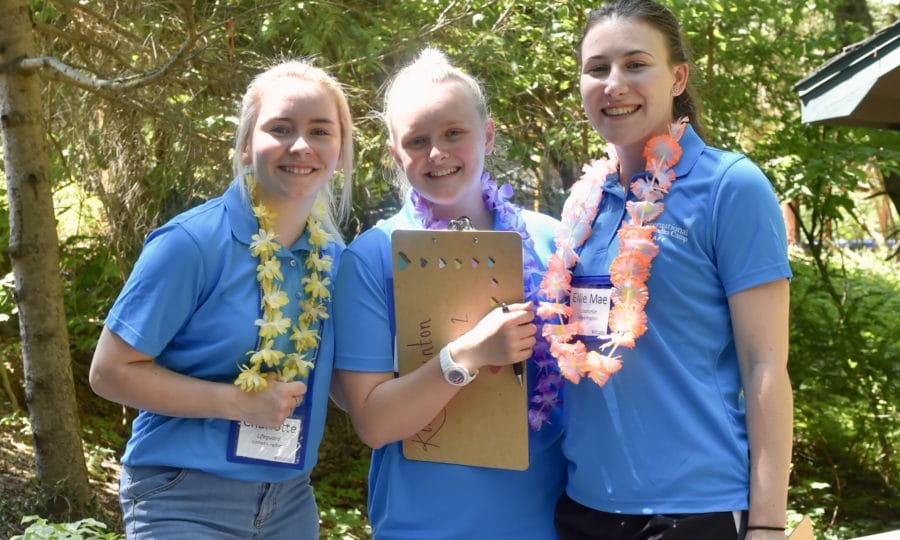 3 girls together smiling with leis