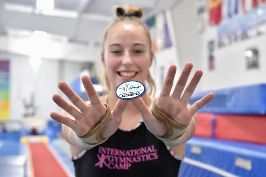 girl holding up ACA sticker